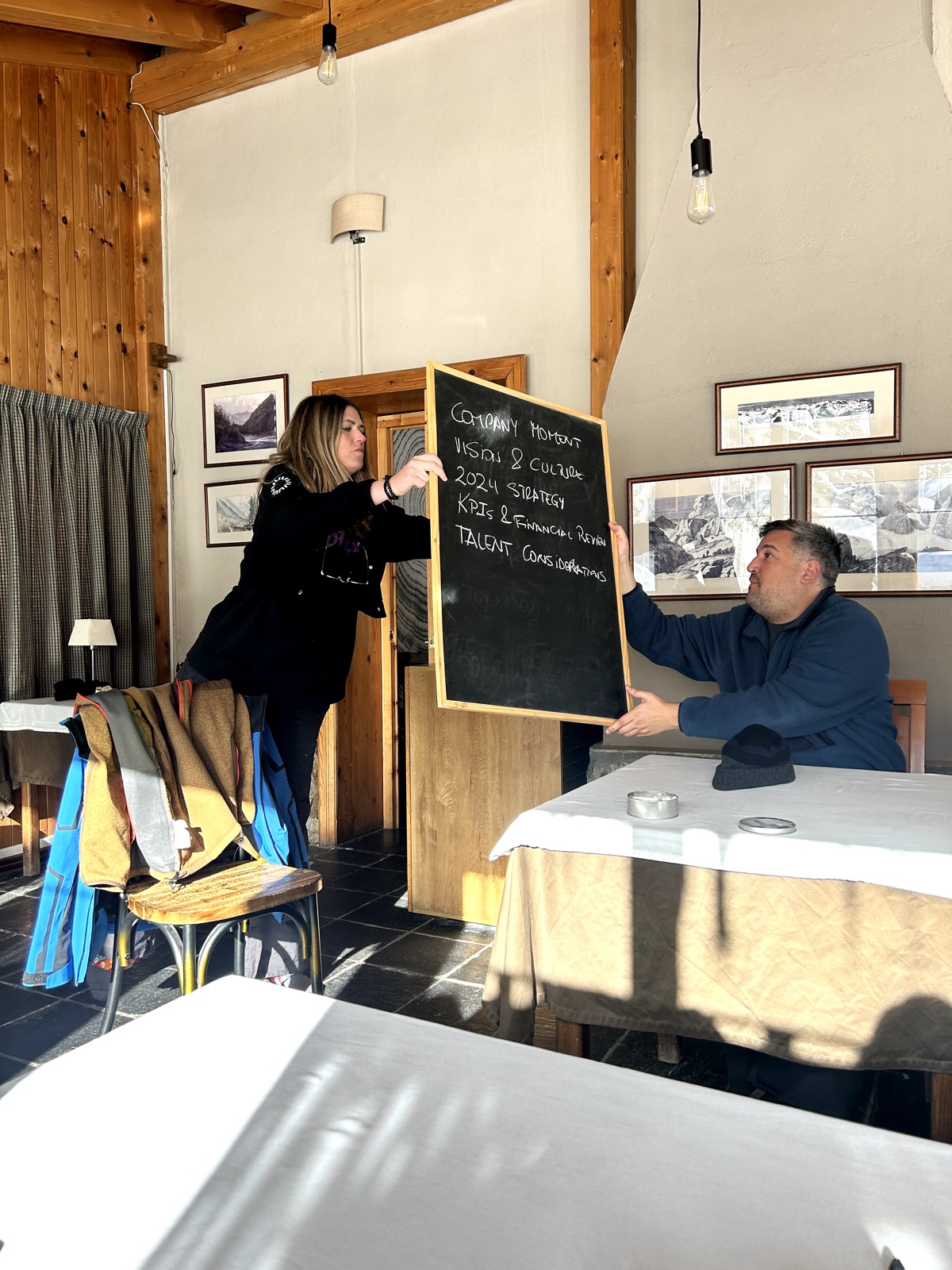 A VIVLA host sketching ideas on a whiteboard in a mountain home